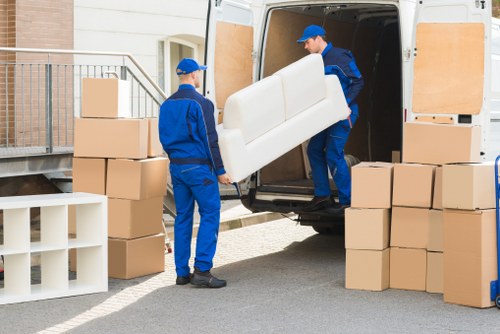 Professional movers handling furniture in Elmstead