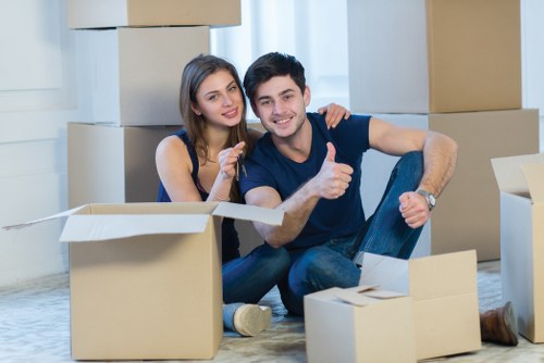 Professional moving van team handling furniture near Elmstead