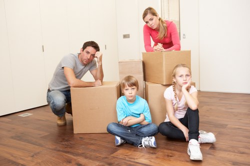 Local movers handling furniture in a residential Elmstead street